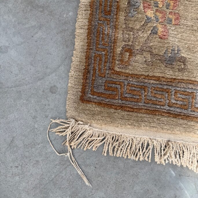 Mazs bēšs paklājs ar ornamentiem